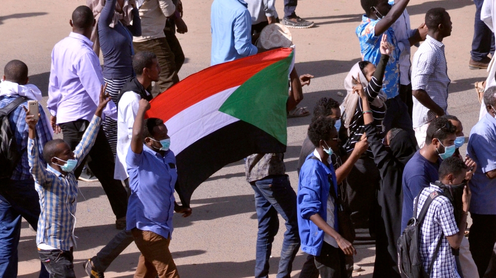 Sudanese demonstrators chant slogans as they march along the street during anti-government protests in Khartoum