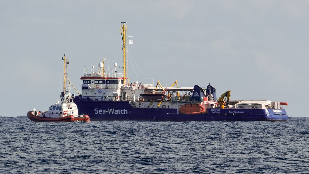 An Italian Coast Guard patroller flanks the Sea-Watch rescue ship off the Sicilian coast where it found shelter, about one nautical mile from Siracusa.