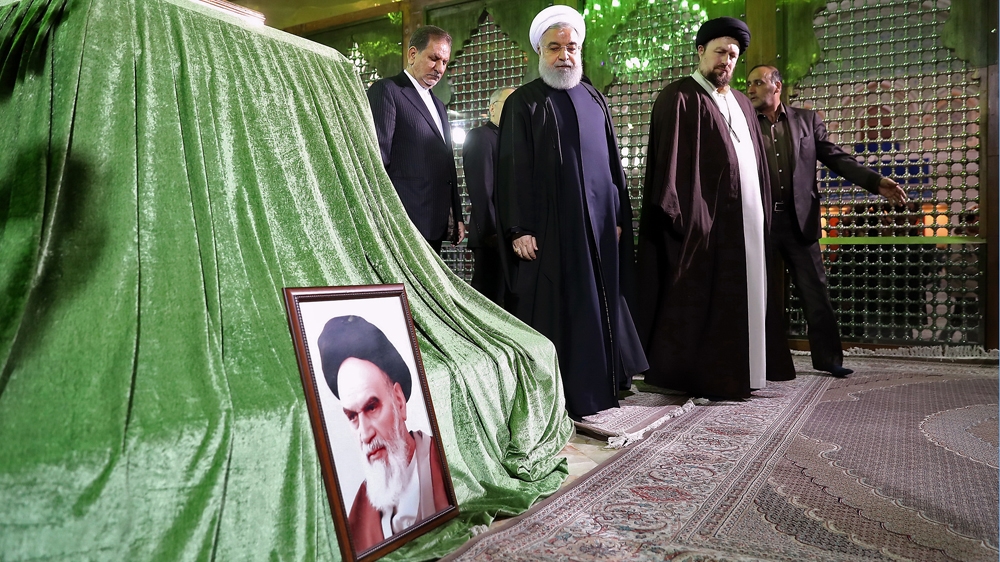 President Hassan Rouhani (C) pays tribute to Khomeini after his death [Presidential office/AFP]