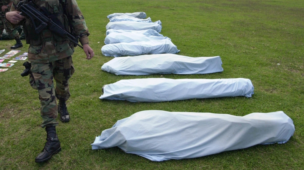 A soldier guards the bodies of some of the16 members of Colombia''s largest rebel army, the Revolutionary Armed Forces of Colombia, or FARC, who were killed by Colombian soldiers, Sunday, April 20, 20