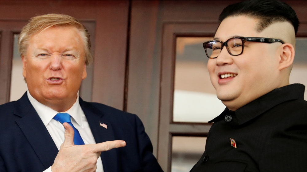 Howard X, a Kim lookalike, and Russell White, a Trump impersonator, pose for a photo at Hanoi's Metropole Hotel [Jorge Silva/Reuters]