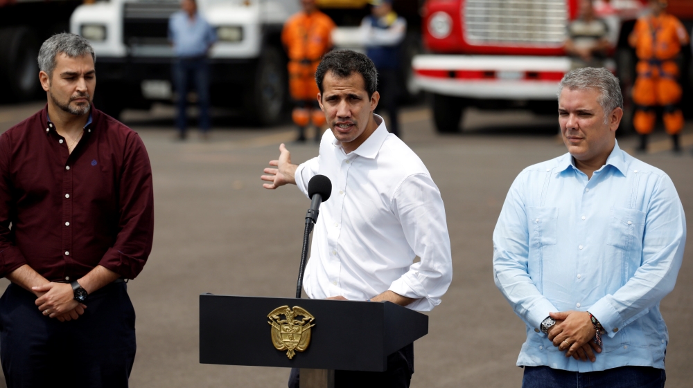 Venezuelan opposition leader Juan Guaido speaks to the media alongside Paraguay's President Mario Abdo Benitez and Colombia's President Ivan Duque [Marco Bello/Reuters]