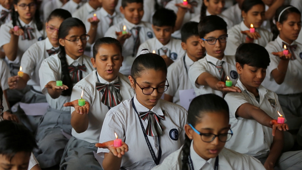 Students in the city of Ahmedabad pay tribute to CRPF personnel who were killed in Kashmir [Amit Dave/Reuters]