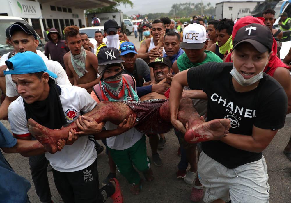 A wounded man is rescued during clashes between the Venezuelan police and protesters that occured at the Simón Bolívar International Bridge, in Cúcuta, Colombia, on 23 February 2019. On Saturday, the