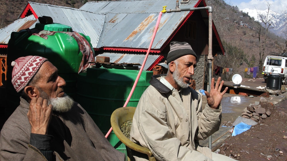Muhammad Yaqoob, right, was handicapped for life and had lost his hearing ability in a 2001 shelling [Shuaib Bashir/Al Jazeera]
