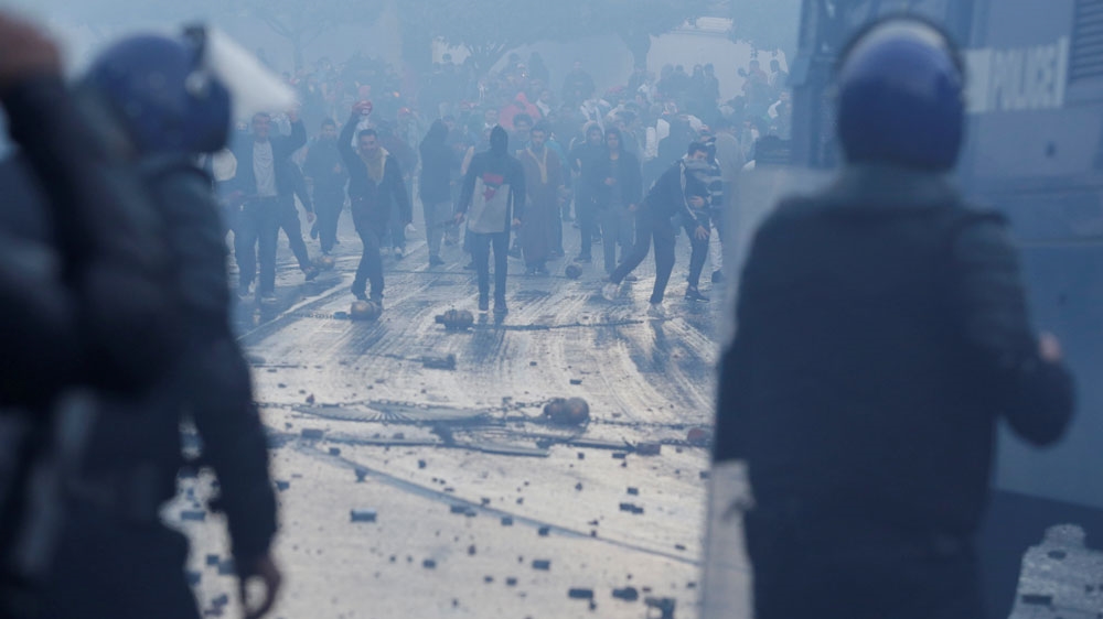 Police used tear gas to disperse crowds as people march to protest against President Abdelaziz Bouteflika's plan to seek a fifth term in Algiers on February 22 [Ramzi Boudina/Reuters]
