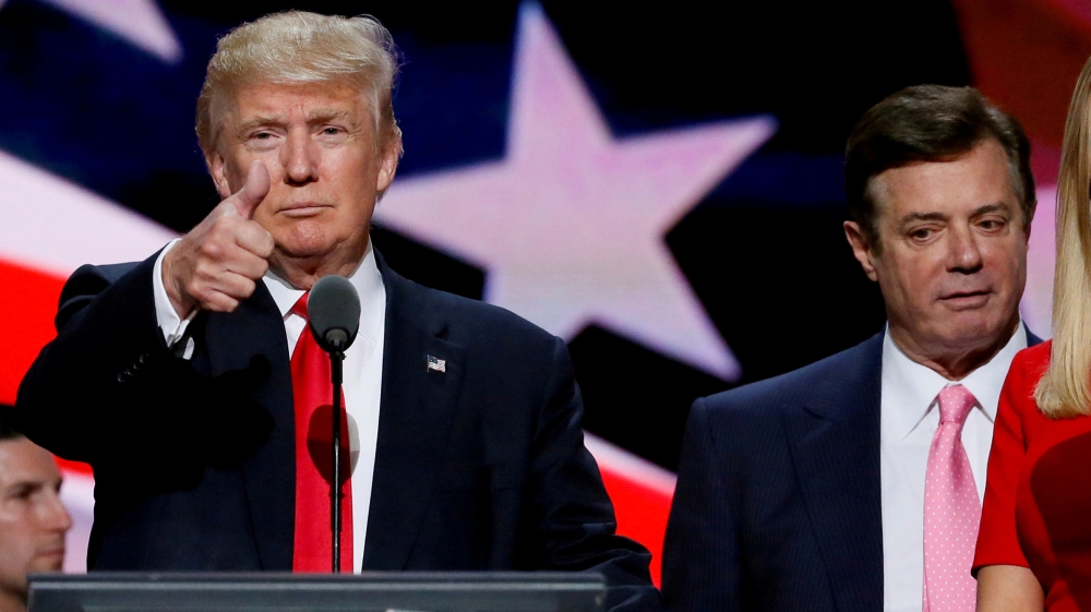 Then-Republican presidential nominee Donald Trump gives a thumbs up as his campaign manager Paul Manafort looks on during Trump's walk-through at the Republican National Convention in Cleveland [File: Rick Wilking/Reuters]