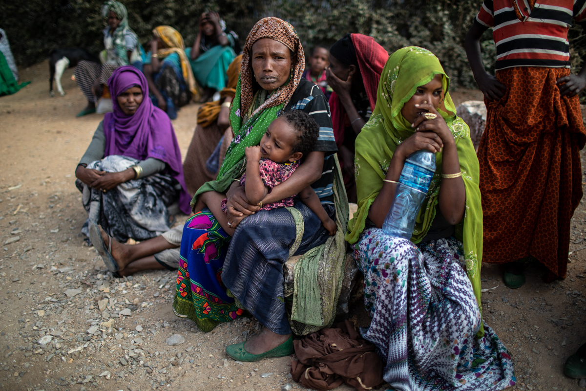 People wait outside a distribution point to receive their USAID rations in Kersa district, Oromia Region, on February 9, 2018. “If people didn’t receive this aid they would have to migrate. It is safe