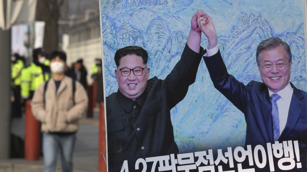 A banner showing a photo of North Korean leader Kim Jong Un and South Korean President Moon Jae-in, right, is displayed to wish for peace on the Korean