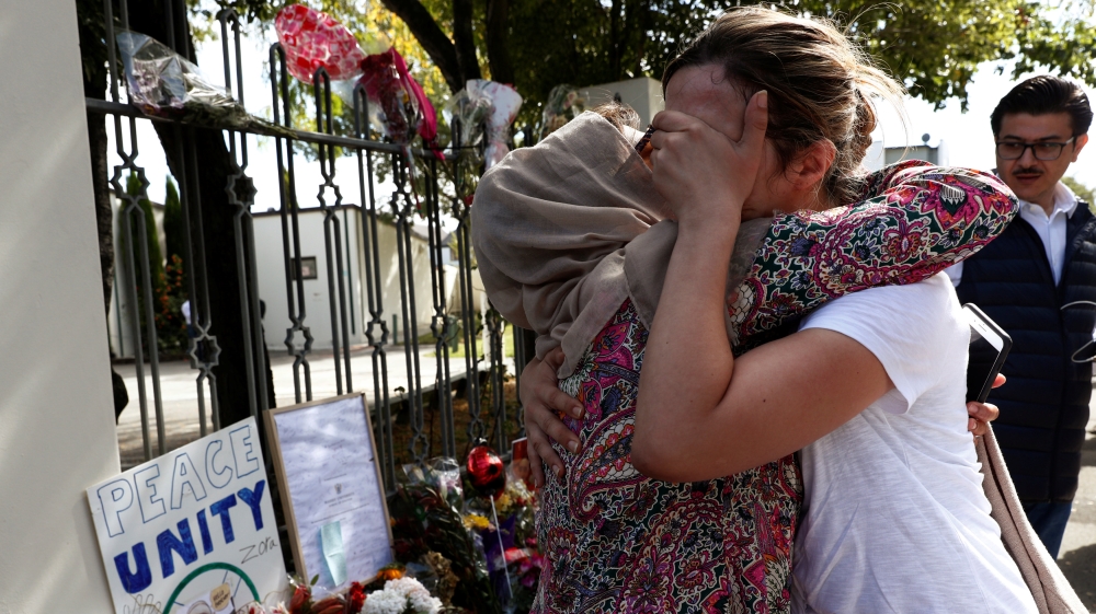 A woman cries next to a tribute to victim Hussein Al-Umari outside Al-Noor mosque after it was reopened in Christchurch, New Zealand, March 23, 2019