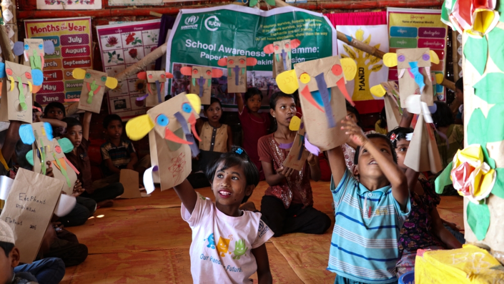 Rohingya children learn about elephants by singing songs and making elephant masks [Susannah Savage/Al Jazeera]