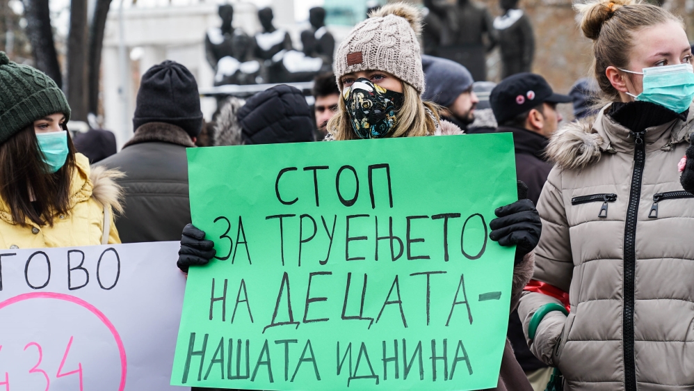 'Stop poisoning our only children' reads a banner at a protest in Skopje [Joi Lee/Al Jazeera]