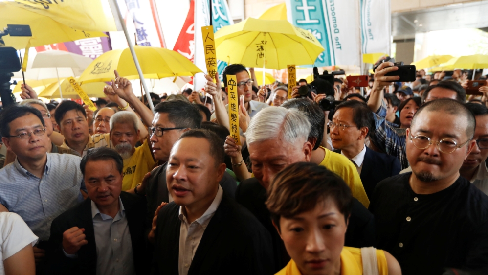 (L-R) Pro-democracy activists Lee Wing-tat, Chan Kin-man, Benny Tai, Chu Yiu-ming, Tanya Chan and Shiu Ka-chun arrive at the court for sentencing on their involvement in the Occupy Central, also known