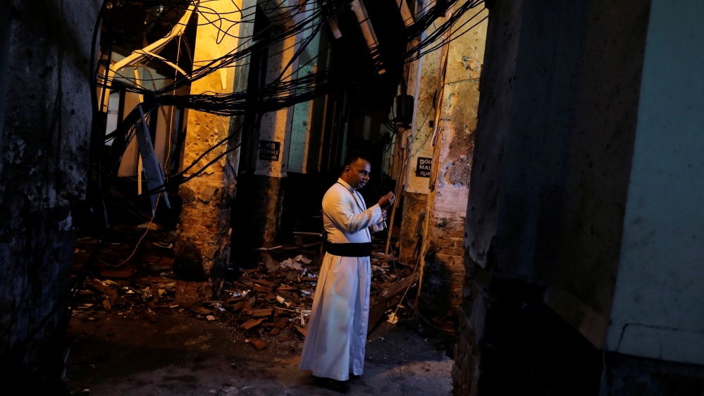 A clergyman talks to the media inside St. Anthony's Shrine [Thomas Peter/Reuters]