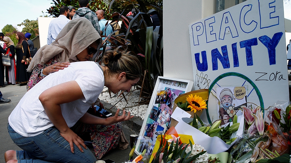 A woman cries next to a tribute to victim Hussein Al-Umari outside Al-Noor mosque after it was reopened in Christchurch, New Zealand, March 23, 2019. REUTERS/Edgar Su