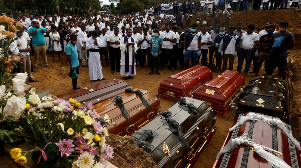 FILE PHOTO: People participate in a mass funeral in Negombo