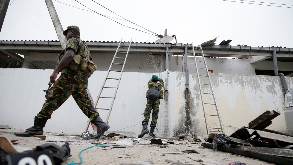 Security personnel seen at the site of an overnight gun battle between troops and suspected fighters on the east coast of Sri Lanka, in Kalmunai [Dinuka Liyanawatte/Reuters]