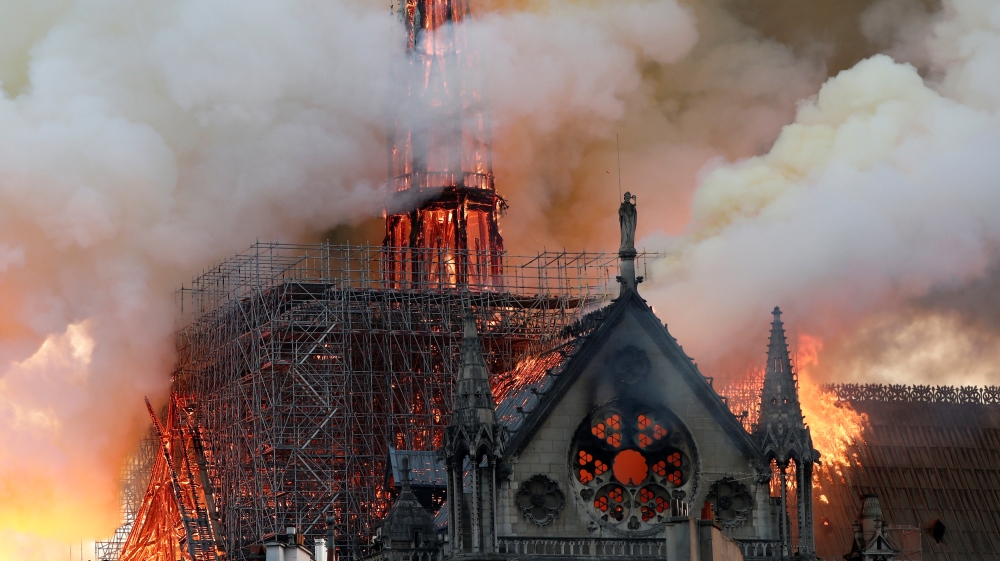 The iconic structure in central Paris in flames [Benoit Tessier/Reuters]