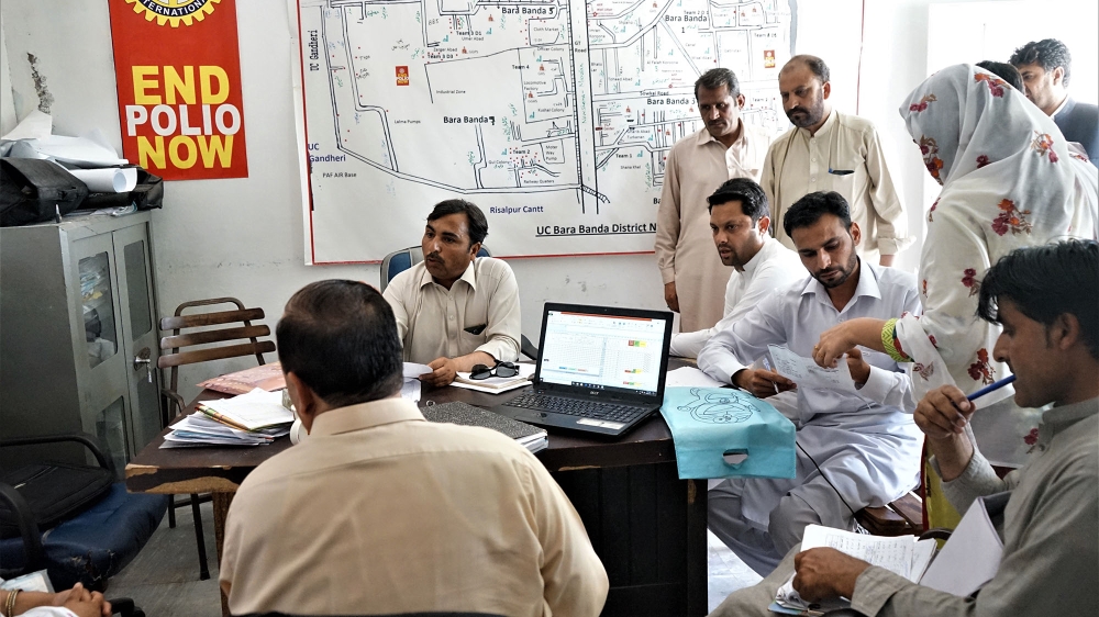 The team at YCP discusses the polio campaign's successes and failures in Nowshera during a recent polio immunisation campaign [Sabrina Toppa/Al Jazeera]