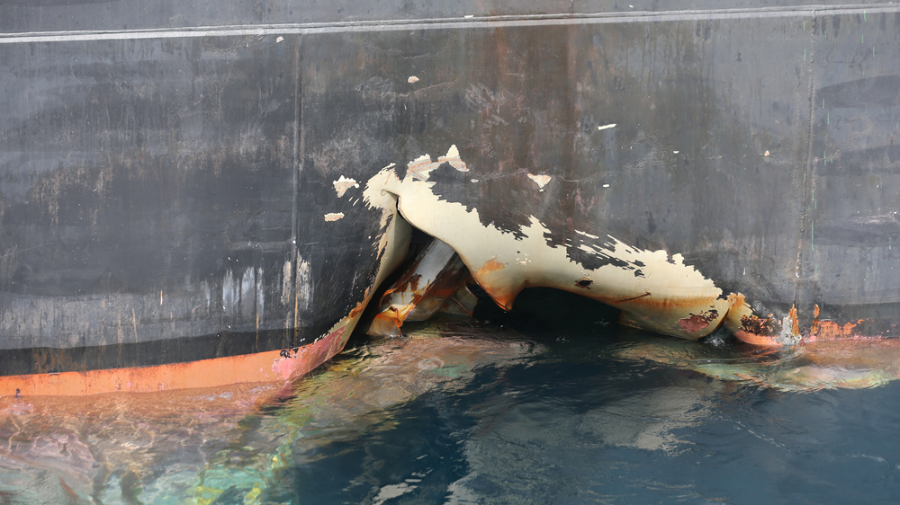 The damaged Andrea Victory vessel is seen off the Port of Fujairah on Monday [Satish Kumar/Reuters]