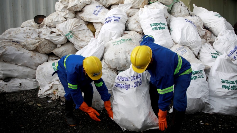 Workers from a recycling company load the garbage collected and brought from Mount Everest in Kathmandu