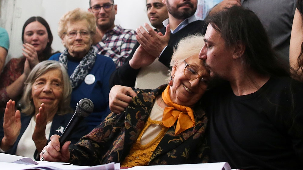 Javier Matias Darroux Mijalchuk, son of Elena Mijalchuk and Juan Manuel Darroux, who disappeared during Argentina’s former 1976-1983 dictatorship, comforts the president of human rights organisation Abuelas de Plaza de Mayo
