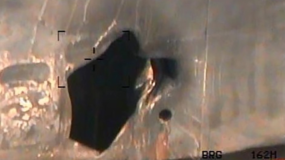 One of the images shows a hole on the hull of the Kokuka Courageous, which the US said was caused by a mine [US Department of Defense via AFP]