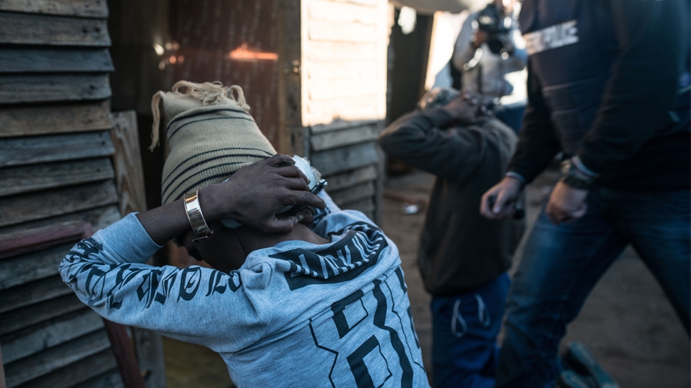 Police carry out raids in Philippi East, where 13 people were killed in a single weekend earlier this month [Shaun Swingler/Al Jazeera]