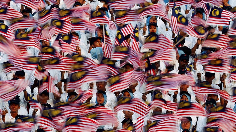 The Malaysian flag held aloft during the annual independence day parade