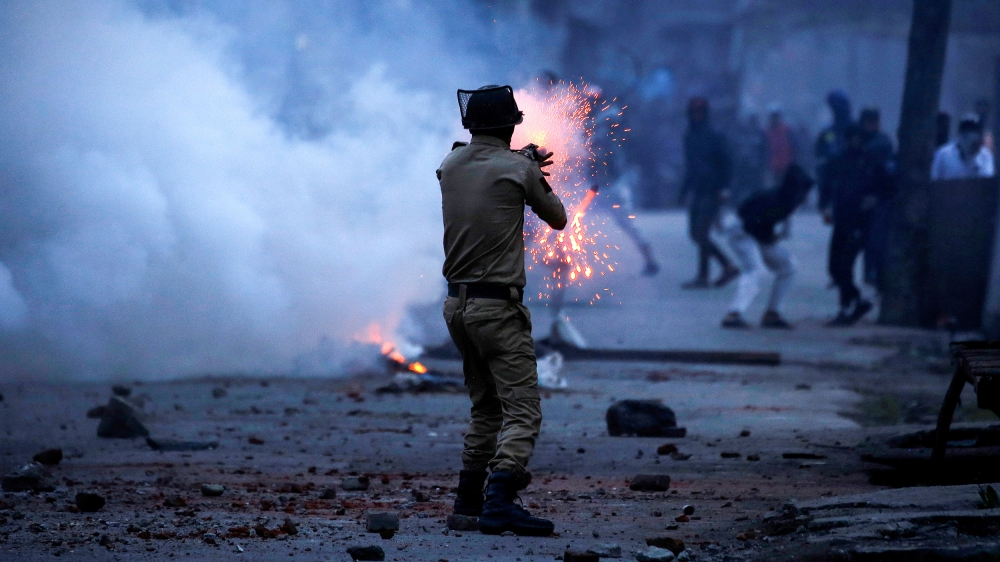 An Indian police officer fires a tear gas shell towards demonstrators, during a protest against the recent killings in Kashmir, in Srinagar May 8, 2018. REUTERS/Danish Ismail TPX IMAGES OF THE DAY