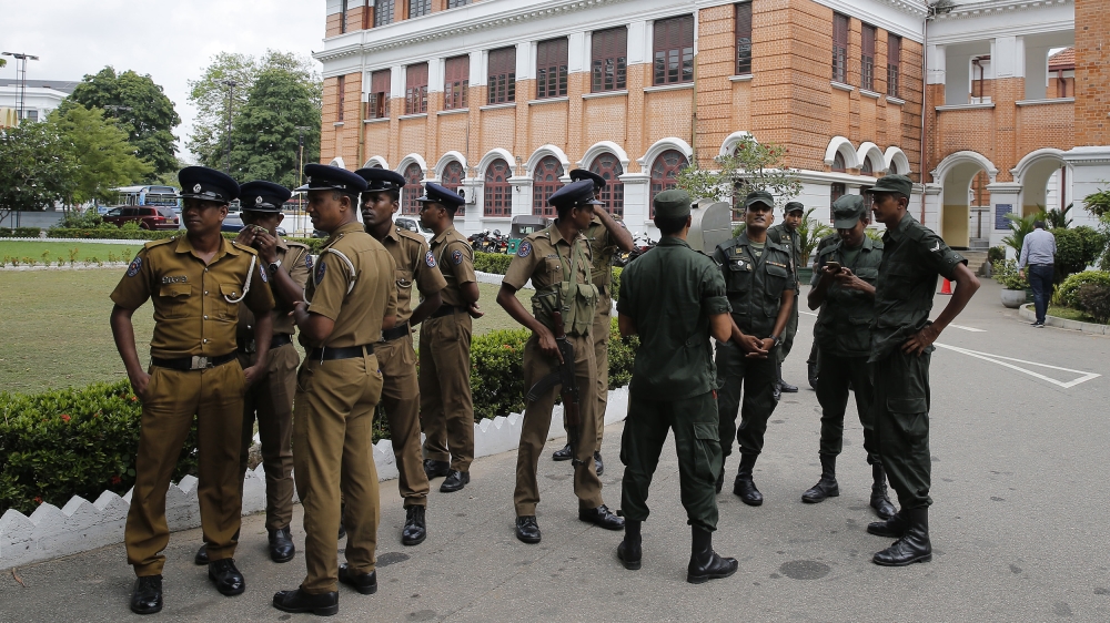 Sri Lankan police officers arrive at a public school to conduct a search in Colombo, Sri Lanka, Sunday, May 5, 2019.