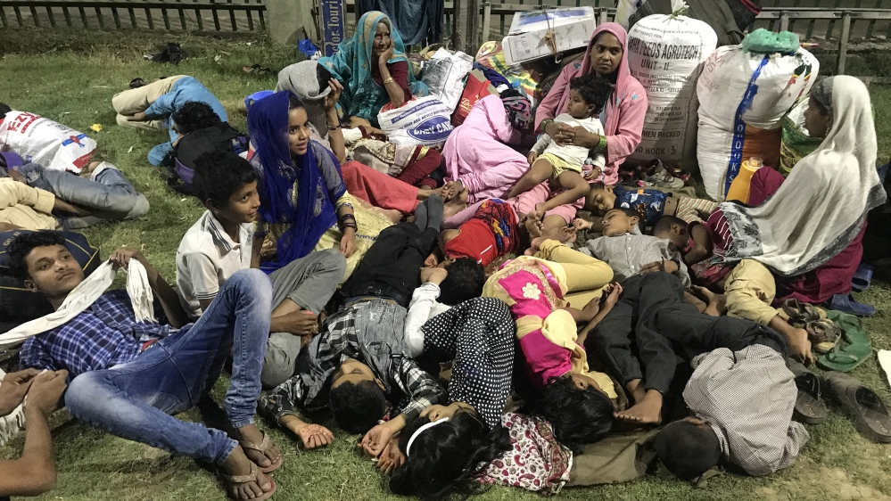 People from various parts of India wait at a bus terminal during restrictions as they wait to leave Srinagar [Zubair Sofi/Al Jazeera]