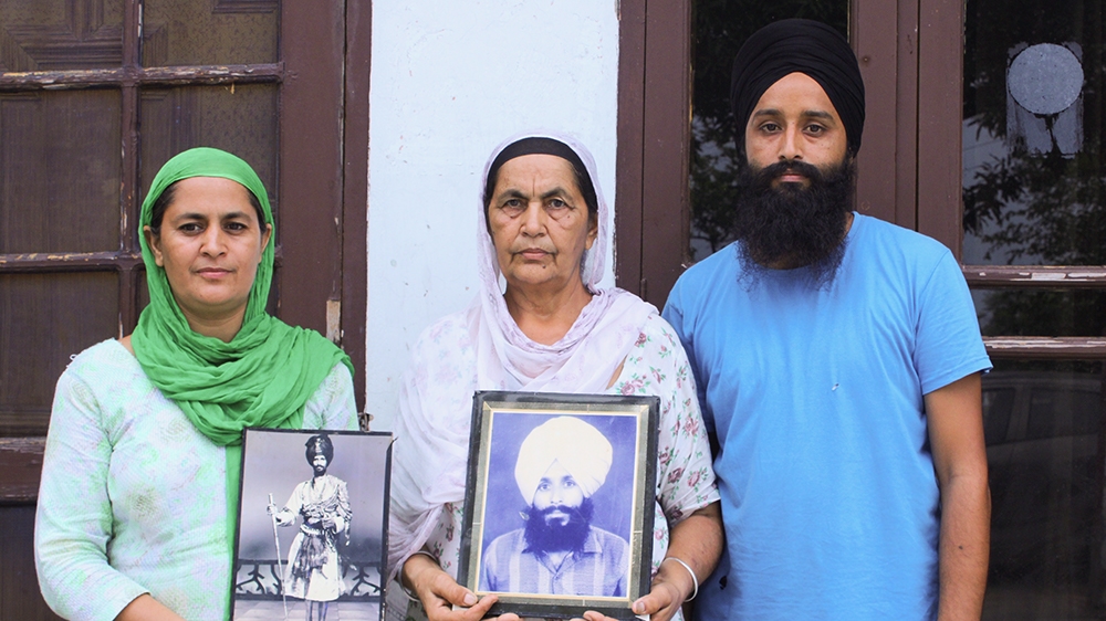 Simarjeet Kaur, centre, lost four family members in alleged police encounters
