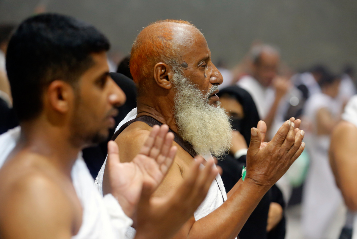 Muslim pilgrims pray after they cast stones at a pillar symbolizing the stoning of Satan, in a ritual called "Jamarat," the last rite of the annual hajj, on the first day of Eid al-Adha, in Mina near