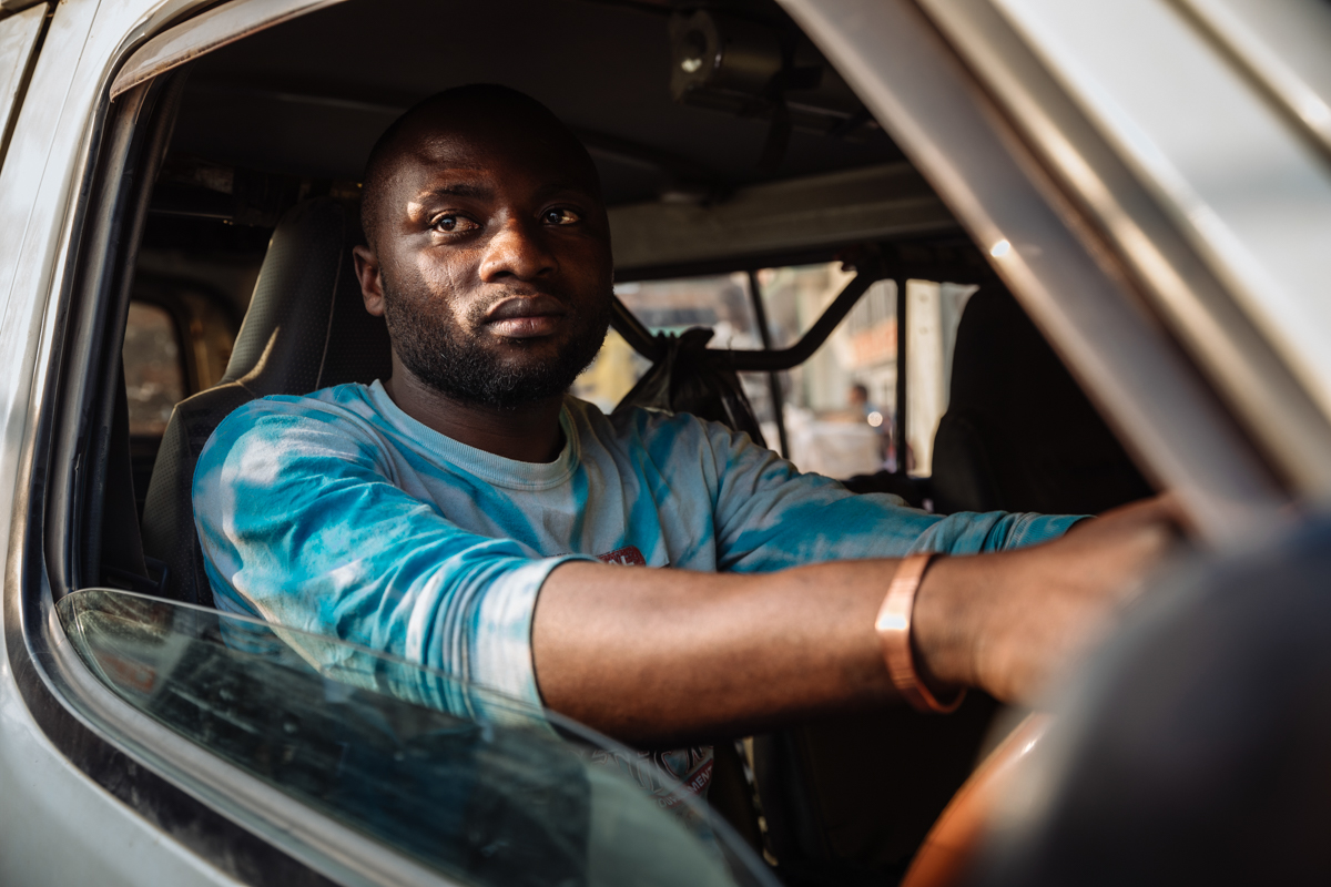 Bus driver Mumbere Sindani Olivier transports passengers along roads cutting through Ebola-affected areas of the Democratic Republic of the Congo. He is trained to detect symptoms of Ebola among passe