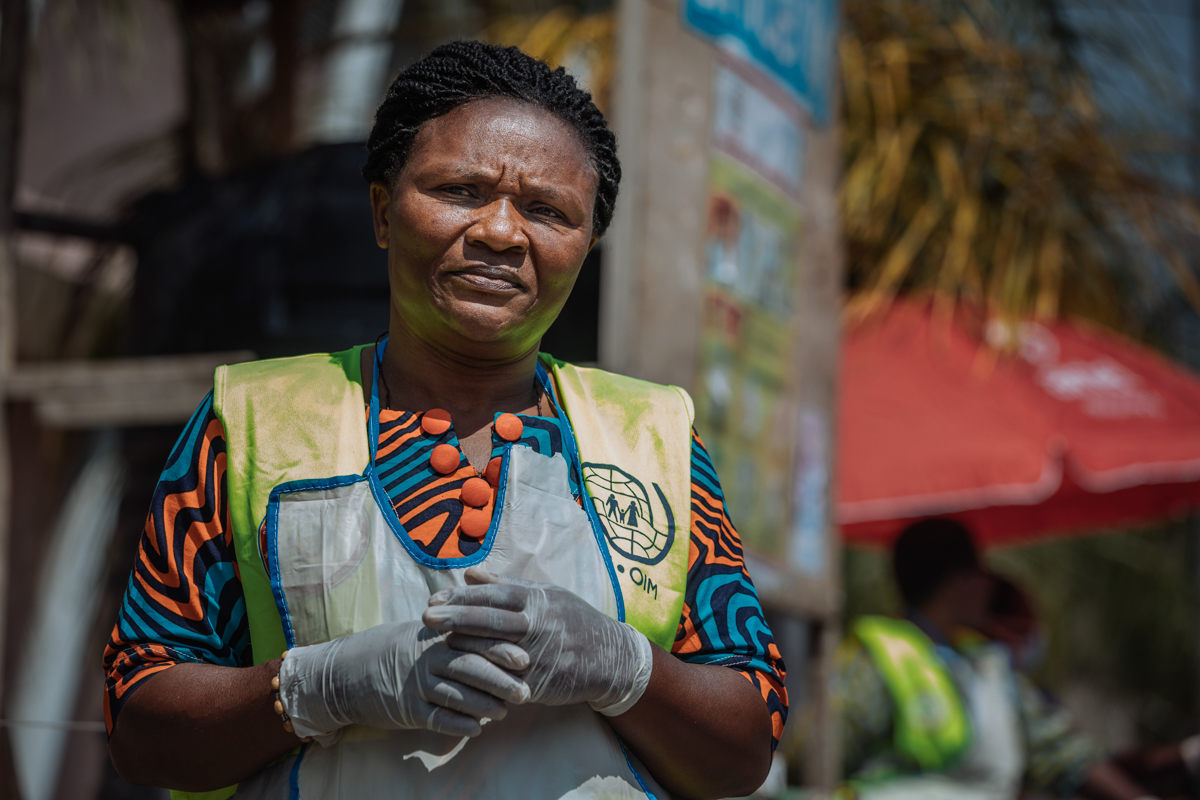 Bita Bernadette observes travelers for symptoms of Ebola as they cross the Grande Barrière Point of Entry in Goma, one of two main gateways linking the Democratic Republic of the Congo and Rwanda. Fro