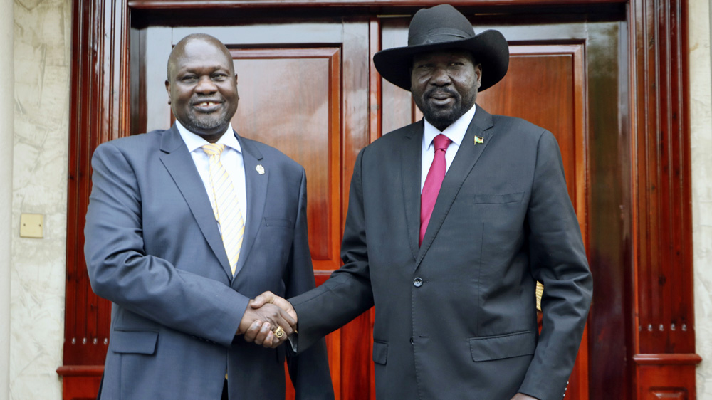South Sudan first Vice President Dr. Riek Machar, left, greets South Sudan President Salva Kiir, right, in Juba, South Sudan [File: AP Photo/Sam Mednick]