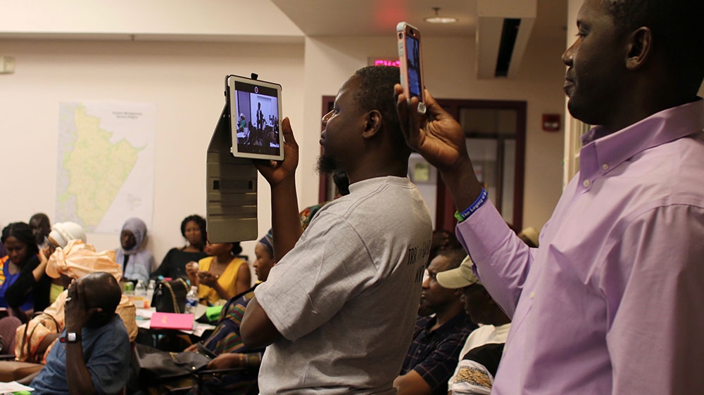 Attendees of the commission’s Maryland tour stop to photograph and live stream the event