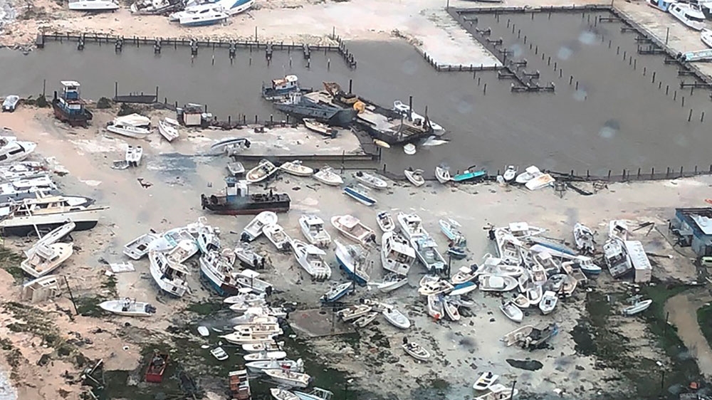 Boats litter the area around a marina in the Bahamas after they were tossed around by Hurricane Dorian