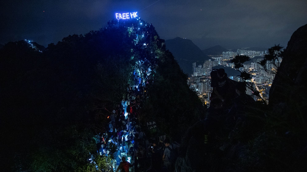 Anti-government protesters carried lanterns and formed a human chain on Friday