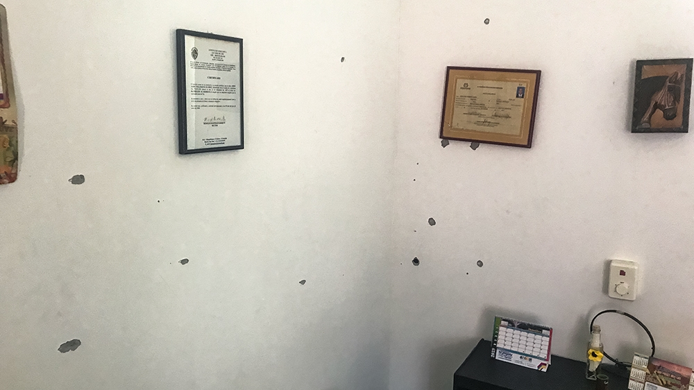 Vasquez’s home with holes from ricocheted bullets fired into his home on Sept 11