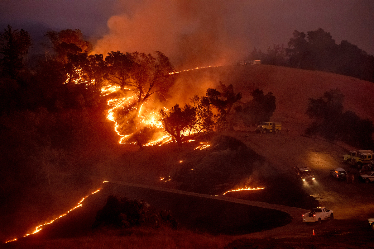 Flames from a backfire, lit by firefighters to slow the spread of the Kincade Fire, burn a hillside in unincorporated Sonoma County, Calif., near Geyservillle on Saturday, Oct. 26, 2019. Authorities a