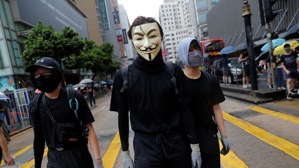 Masked anti-government protesters attend a demonstration in Tsim Sha Tsui district, in Hong Kong