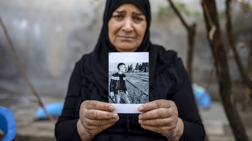 Hamood holds a picture of her son Dara Ali, 18, who was killed in the October 11 attack in Nusaybin