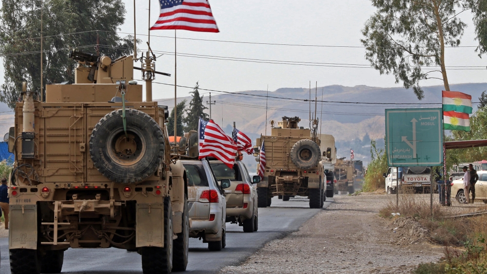 A convoy of US military vehicles arrives near the Iraqi Kurdish town of Bardarash in the Dohuk governorate after withdrawing from northern Syria on October 21, 2019.  SAFIN HAMED / AFP