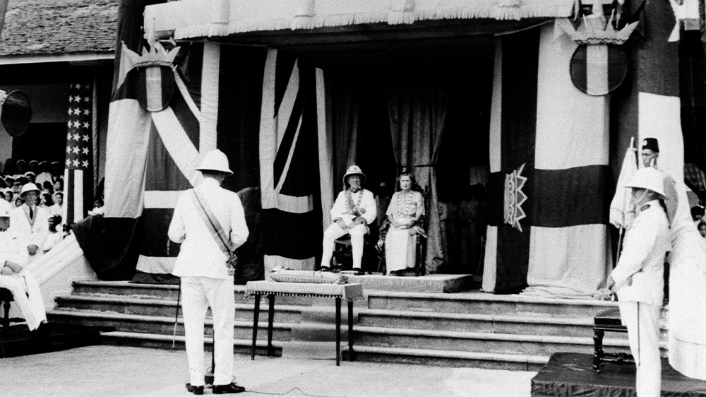 Seated on gold cloth-draped dais, ‘White Rajah’ Charles Vyner Brooke and his wife the Ranee of Sarawak, Sylvia Leonora Brooke, celebrate the centenary of white rule in Sarawak, October 1941.