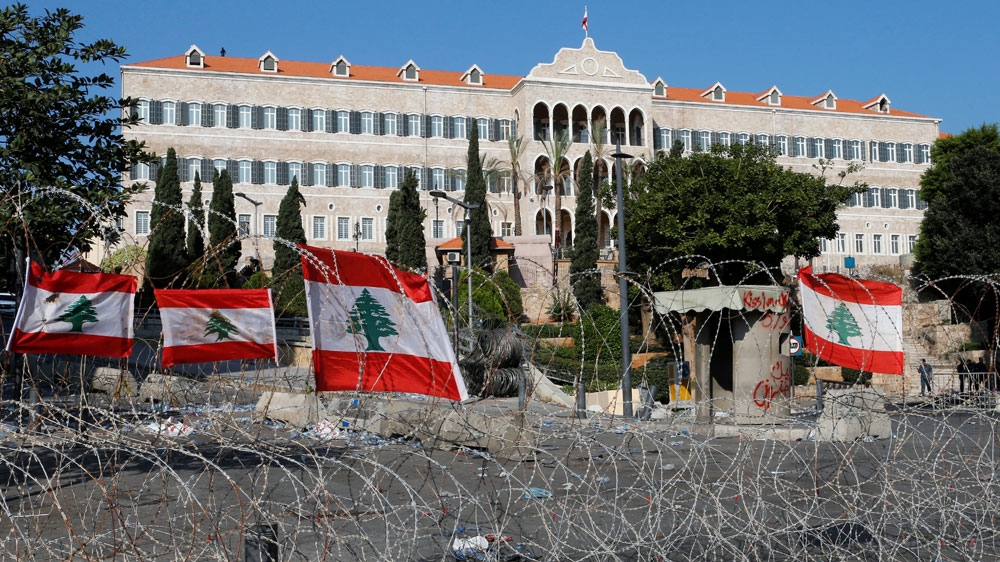 National flags are seen on a razor wire near the government palace in Beirut
