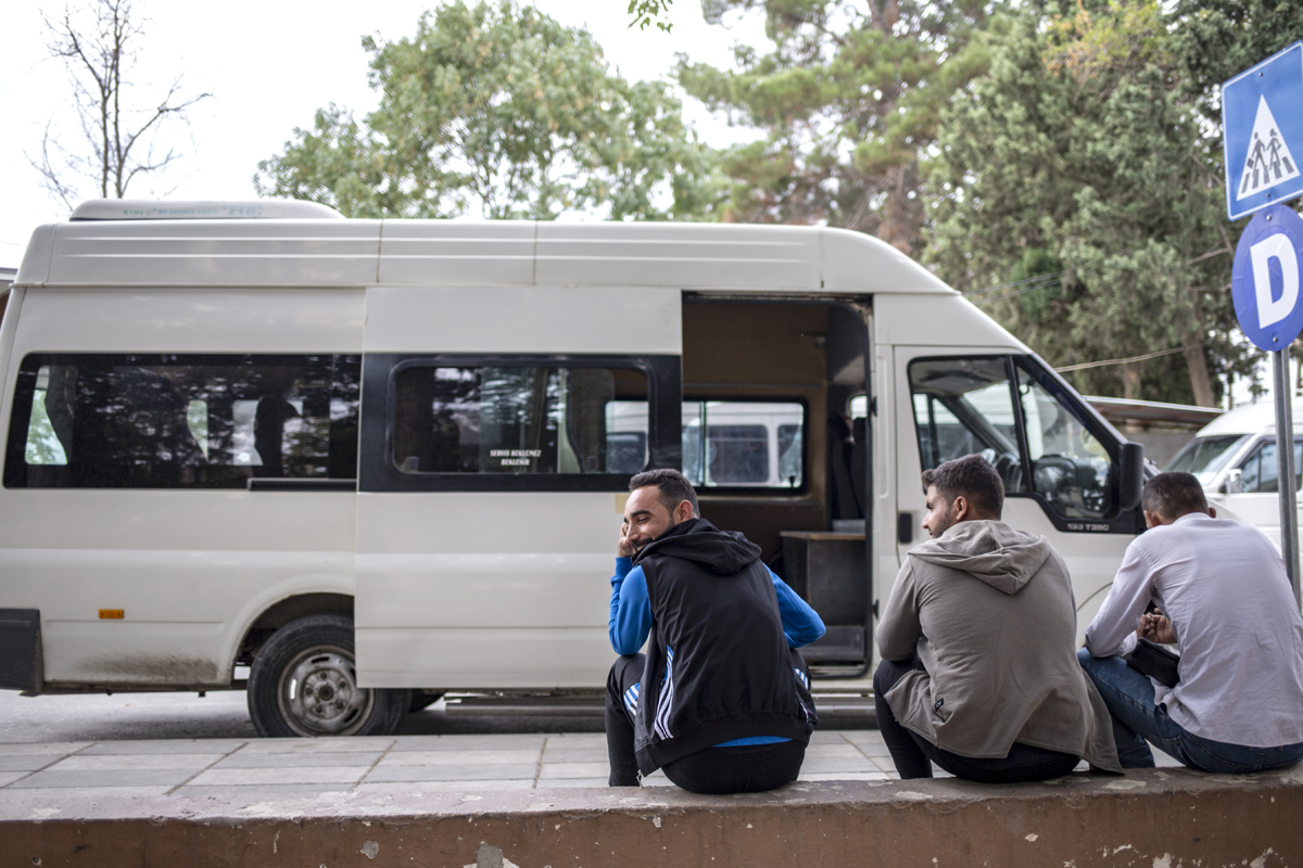 Empty buses wait to be filled with Syrian families exiting the Karkamis border crossing