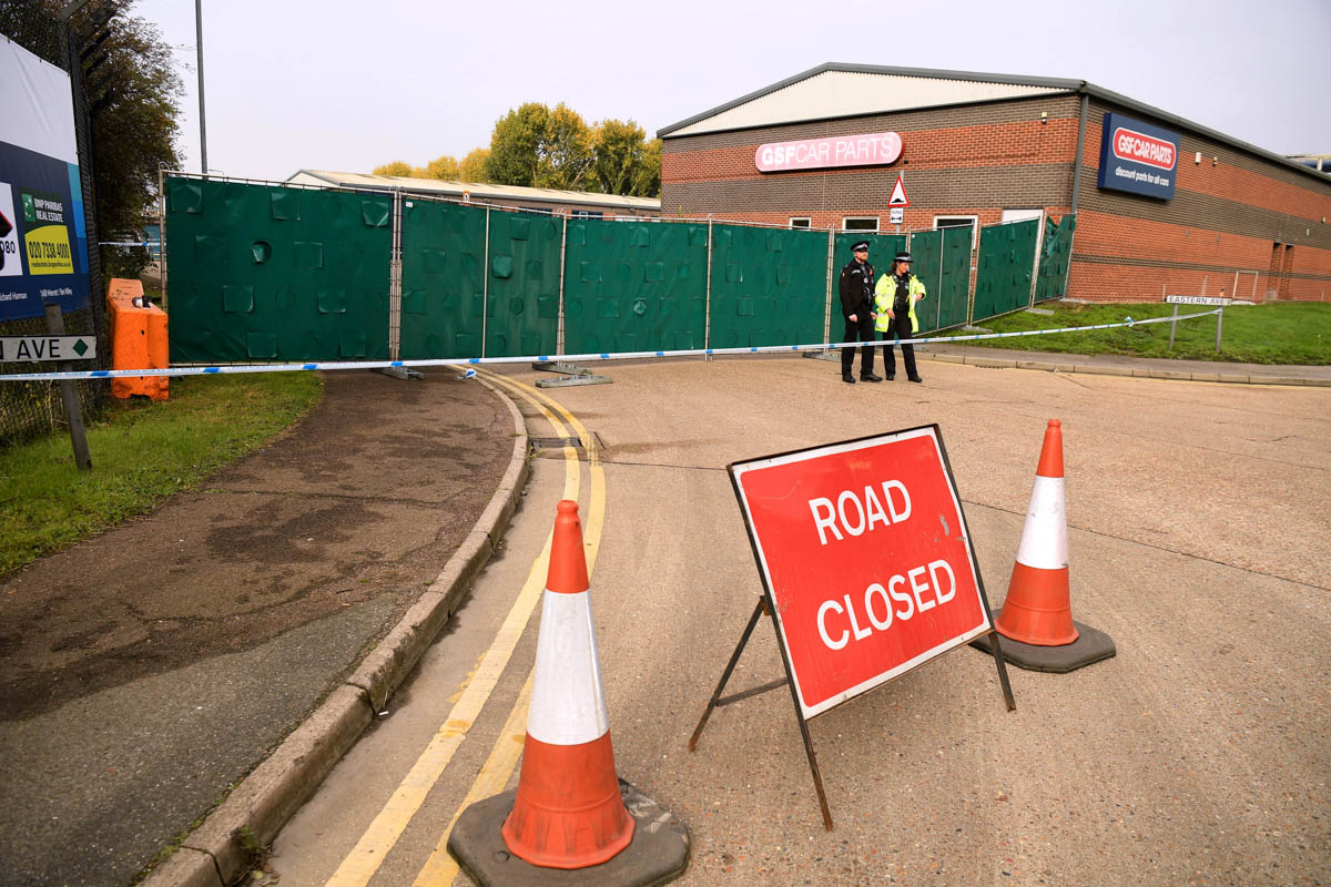 Police stand near the site where 39 bodies were discovered in the back of a lorry on October 23, 2019 in Thurrock, England. The lorry was discovered early Wednesday morning in Waterglade Industrial Pa
