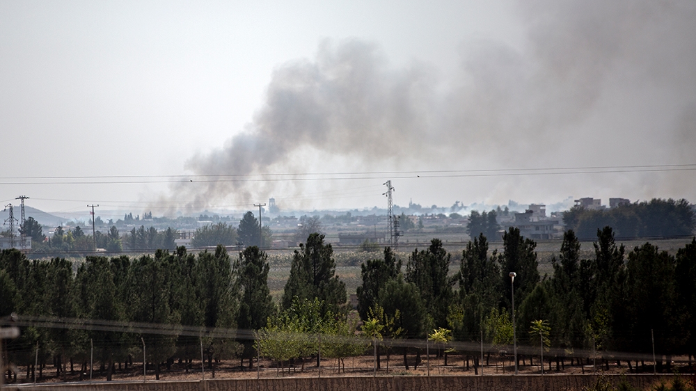 Smoke rises from the northeastern Syrian town of Tal Abyad  [Hosam Salem/Al Jazeera] 